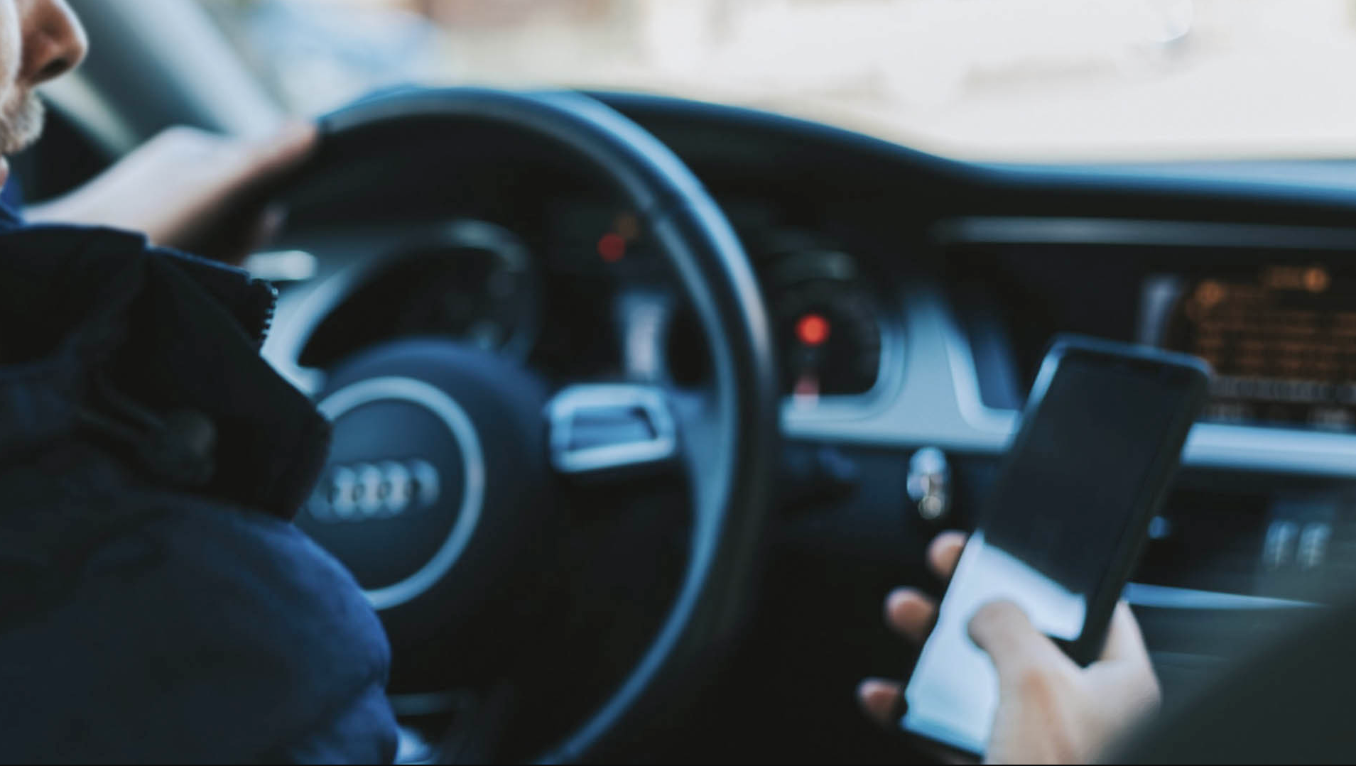 Man drive car with telephone in one hand